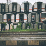 A collection of old train cars on a train track, requiring local junk removal service.