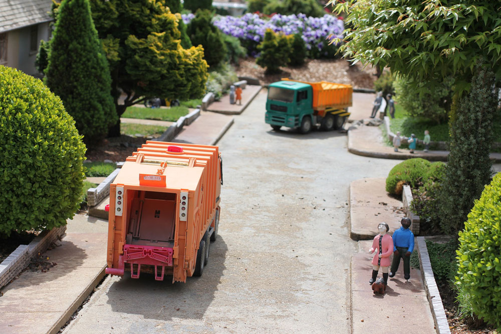 A toy truck from Eastside Junk driving down a street.