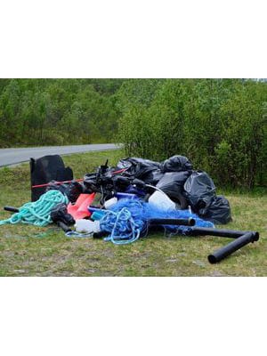 We tackle waste management by addressing a pile of garbage on the side of a road.