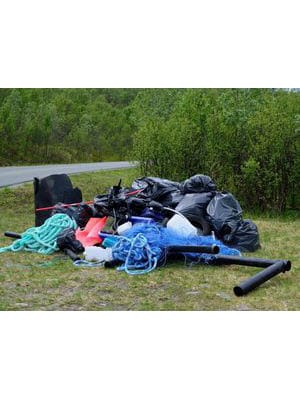 We tackle waste management by addressing a pile of garbage on the side of a road.