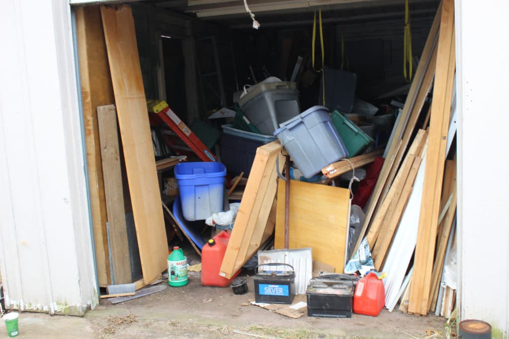 A cluttered garage full of miscellaneous items.
