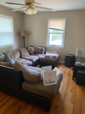 A living room with a couch and a box on the floor.