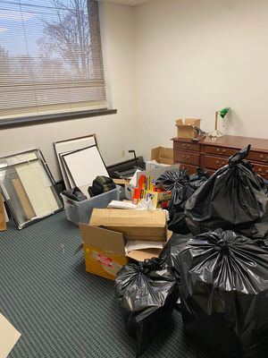 A cluttered room filled with an abundance of rubbish.