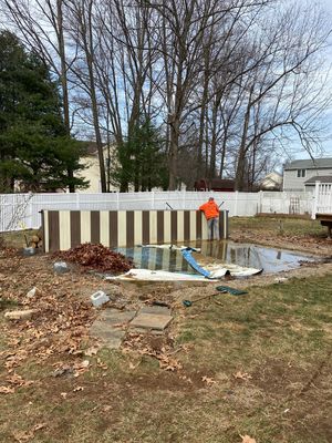 A backyard with a pool under construction.